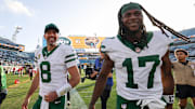 Dec 15, 2024; Jacksonville, Florida, USA; New York Jets quarterback Aaron Rodgers (8) and wide receiver Davante Adams (17) celebrates after beating the Jacksonville Jaguars at EverBank Stadium.
