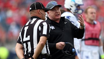 Sep 28, 2024; Oxford, Mississippi, USA; Kentucky Wildcats head coach  Mark Stoops talks with an official during a time out during the first half against the Mississippi Rebels at Vaught-Hemingway Stadium. Mandatory Credit: Petre Thomas-Imagn Images