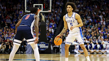 Mar 27, 2025; Newark, NJ, USA; Duke Blue Devils guard Tyrese Proctor (5) handles the ball against Arizona Wildcats guard Jaden Bradley (0) during the first half during an East Regional semifinal of the 2025 NCAA tournament at Prudential Center. Mandatory Credit: Vincent Carchietta-Imagn Images