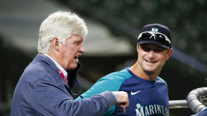 Seattle Mariners majority owner John Stanton, left, talks with bench coach Jared Sandberg (48) during batting practice against the Oakland Athletics at T-Mobile Park in 2021.