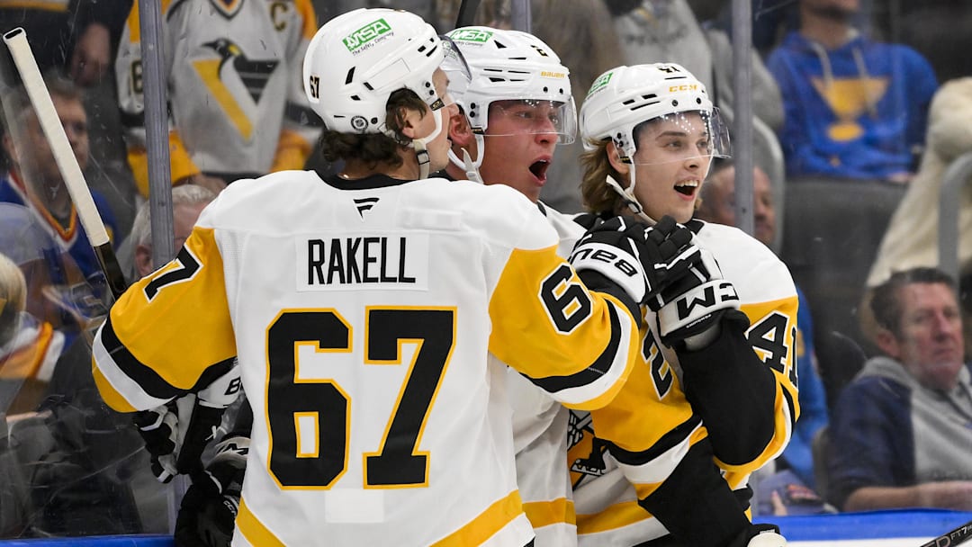 Apr 3, 2025; St. Louis, Missouri, USA;  Pittsburgh Penguins right wing Rutger McGroarty (2) is congratulated by right wing Rickard Rakell (67) and right wing Ville Koivunen (41) after scoring his first NHL goal to tie the game against the St. Louis Blues during the third period at Enterprise Center. Mandatory Credit: Jeff Curry-Imagn Images