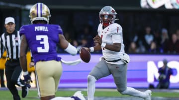 Nov 25, 2023; Seattle, Washington, USA; Washington State Cougars quarterback Cameron Ward (1) scrambles out of the pocket against the Washington Huskies during the second quarter at Alaska Airlines Field at Husky Stadium. Mandatory Credit: Joe Nicholson-USA TODAY Sports