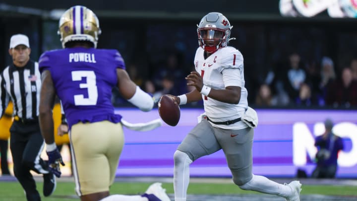 Nov 25, 2023; Seattle, Washington, USA; Washington State Cougars quarterback Cameron Ward (1) scrambles out of the pocket against the Washington Huskies during the second quarter at Alaska Airlines Field at Husky Stadium. Mandatory Credit: Joe Nicholson-USA TODAY Sports