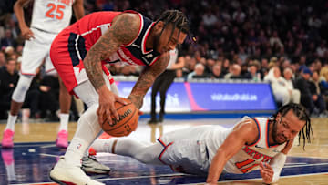 Nov 3, 2025; New York, New York, USA; Washington forward Cam Whitmore (1) battles New York Knicks guard Jalen Brunson (11) for a ball during the second half at Madison Square Garden. Mandatory Credit: Lucas Boland-Imagn Images