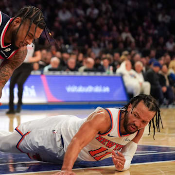 Nov 3, 2025; New York, New York, USA; Washington forward Cam Whitmore (1) battles New York Knicks guard Jalen Brunson (11) for a ball during the second half at Madison Square Garden. Mandatory Credit: Lucas Boland-Imagn Images
