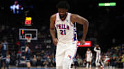 Joel Embiid limps to the bench during a time-out against the Memphis Grizzlies.