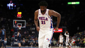 Joel Embiid limps to the bench during a time-out against the Memphis Grizzlies.