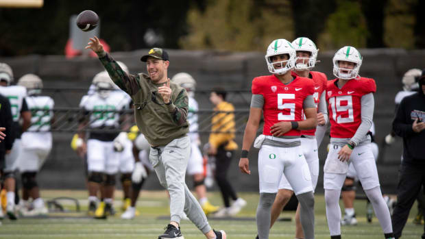 Oregon offensive coordinator and quarterbacks coach Will Stein throws during practice.