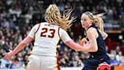Mar 31, 2025; Spokane, WA, USA; UConn Huskies guard Paige Bueckers (5) controls the ball against USC Trojans guard Avery Howell (23) during the second half of a Elite 8 NCAA Tournament basketball game at Spokane Arena. Mandatory Credit: James Snook-Imagn Images