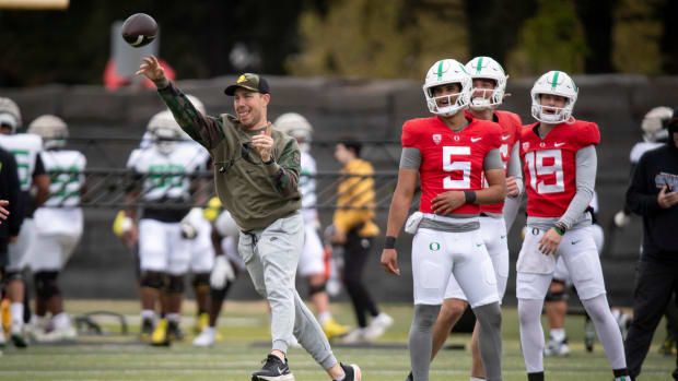 Oregon offensive coordinator and quarterbacks coach Will Stein throws during practice with the Oregon Ducks
