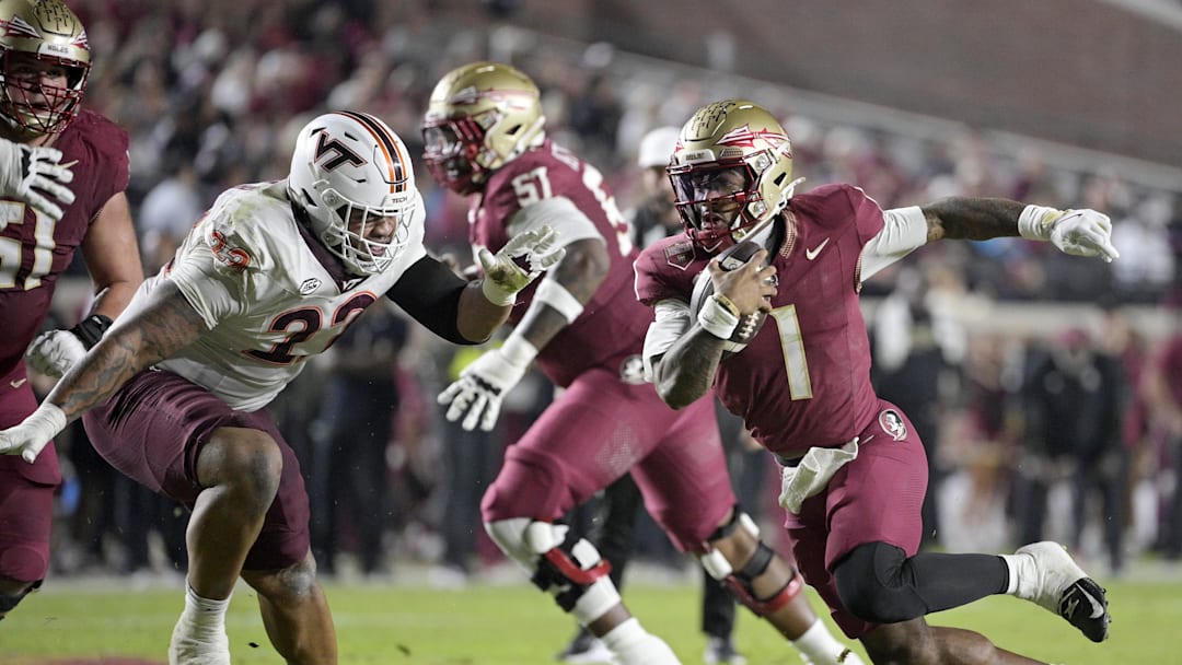 Nov 15, 2025; Tallahassee, Florida, USA; Florida State Seminoles quarterback Thomas Castellanos (1) runs the ball past Virginia Tech Hokies defensive lineman Kelvin Gilliam Jr. (22) during the first half at Doak S. Campbell Stadium. Mandatory Credit: Melina Myers-Imagn Images