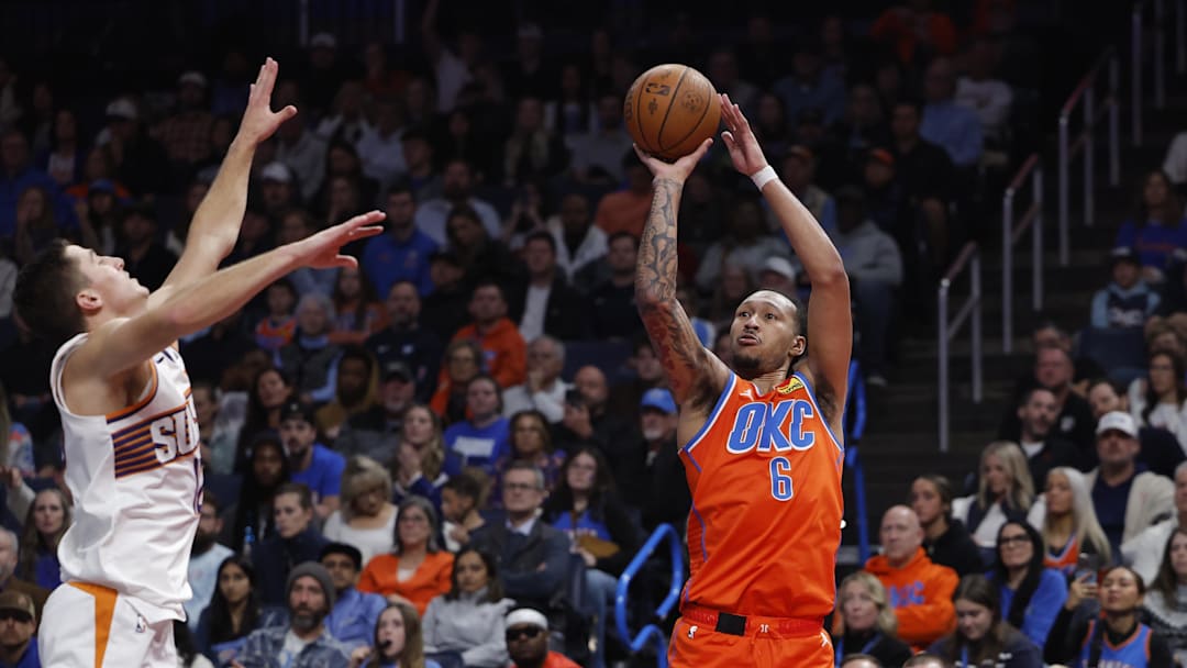 Nov 28, 2025; Oklahoma City, Oklahoma, USA; Oklahoma City Thunder forward Jaylin Williams (6) shoots a three point basket over Phoenix Suns guard Collin Gillespie (12) during the second half at Paycom Center. Mandatory Credit: Alonzo Adams-Imagn Images
