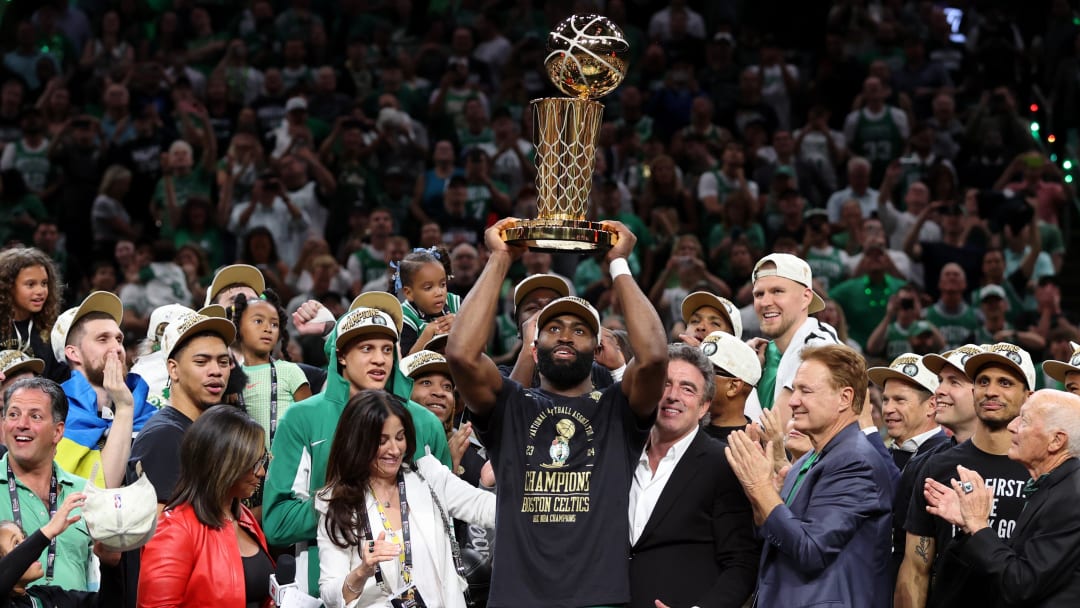 Boston Celtics guard Jaylen Brown lifts the Larry O’Brien Trophy after the Celtics won the 2024 NBA championship.
