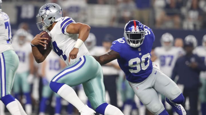 Sep 10, 2017; Arlington, TX, USA; Dallas Cowboys quarterback Dak Prescott (4) scrambles against New York Giants defensive end Jason Pierre-Paul (90) in the first quarter at AT&T Stadium.  