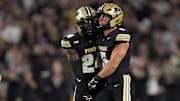 Purdue Boilermakers running back Malachi Thomas (24) celebrates a sack with Purdue Boilermakers linebacker Charles Correa (5)