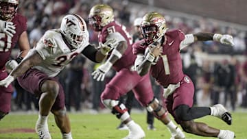 Nov 15, 2025; Tallahassee, Florida, USA; Florida State Seminoles quarterback Thomas Castellanos (1) runs the ball past Virginia Tech Hokies defensive lineman Kelvin Gilliam Jr. (22) during the first half at Doak S. Campbell Stadium. Mandatory Credit: Melina Myers-Imagn Images