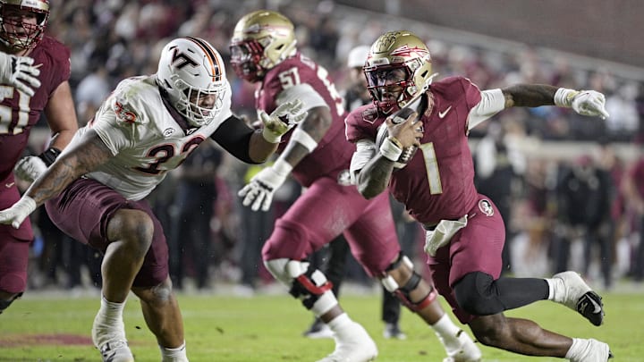 Nov 15, 2025; Tallahassee, Florida, USA; Florida State Seminoles quarterback Thomas Castellanos (1) runs the ball past Virginia Tech Hokies defensive lineman Kelvin Gilliam Jr. (22) during the first half at Doak S. Campbell Stadium. Mandatory Credit: Melina Myers-Imagn Images