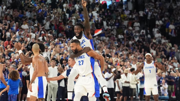 Aug 8, 2024; Paris, France; France centre Mathias Lessort (26) and centre Rudy Gobert (27) celebrate after the game against Germany in a men's basketball semifinal game during the Paris 2024 Olympic Summer Games at Accor Arena. Mandatory Credit: Rob Schumacher-USA TODAY Sports