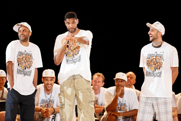 San Antonio Spurs forward Tim Duncan (middle) speaks as teammates Tony Parker (left) and Manu Ginobili (right) listen.