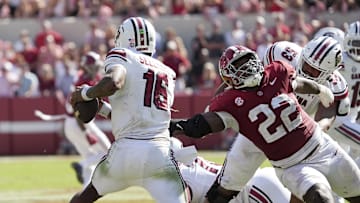 South Carolina Gamecocks quarterback LaNorris Sellers evades a rush by Alabama Crimson Tide defensive lineman LT Overton.