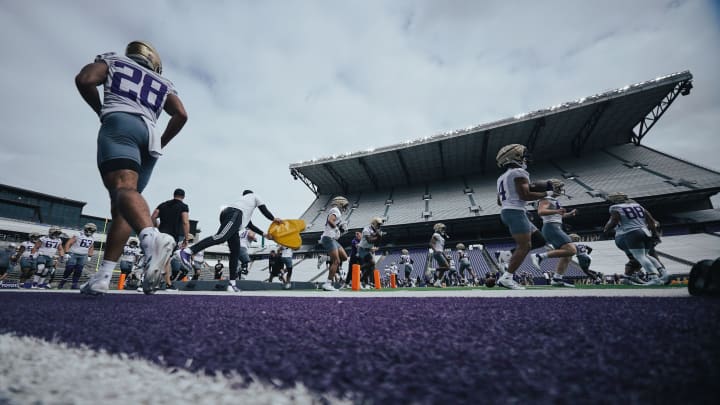 Jordan Washington (4) takes his turn in an RB drill while Sam Adams (28) gets back in line. 