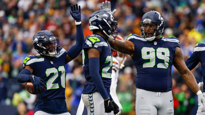 Nov 12, 2023; Seattle, Washington, USA; Seattle Seahawks cornerback Devon Witherspoon (21), cornerback Riq Woolen (27) and defensive end Leonard Williams (99) celebrate following a play against the Washington Commanders during the second quarter at Lumen Field. Mandatory Credit: Joe Nicholson-USA TODAY Sports