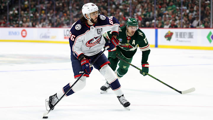 Blue Jackets forward Kirill Marchenko shoots the puck against the Minnesota Wild.