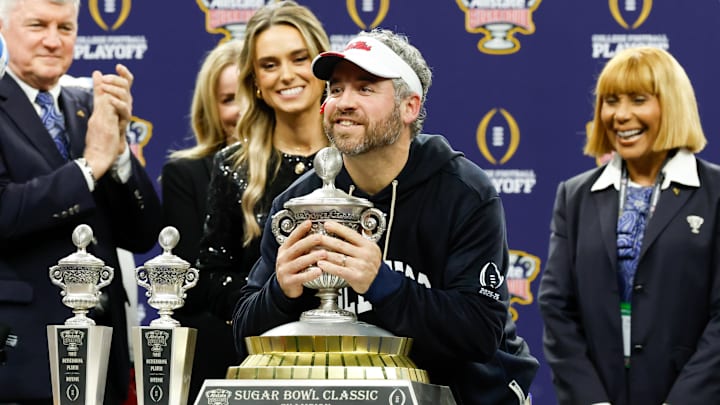 Jan 1, 2026; New Orleans, LA, USA; Mississippi Rebels head coach Pete Golding lifts the trophy after the 2025 Sugar Bowl and quarterfinal game of the College Football Playoff against the Georgia Bulldogs at Caesars Superdome. Mandatory Credit: Amber Searls-Imagn Images