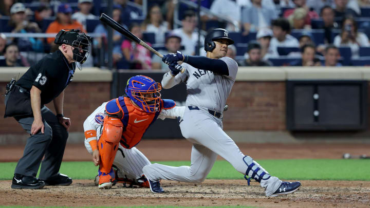 Jun 25, 2024; New York City, New York, USA; New York Yankees right fielder Juan Soto (22) follows through on a solo home run against the New York Mets during the fifth inning at Citi Field. Mandatory Credit: Brad Penner-USA TODAY Sports