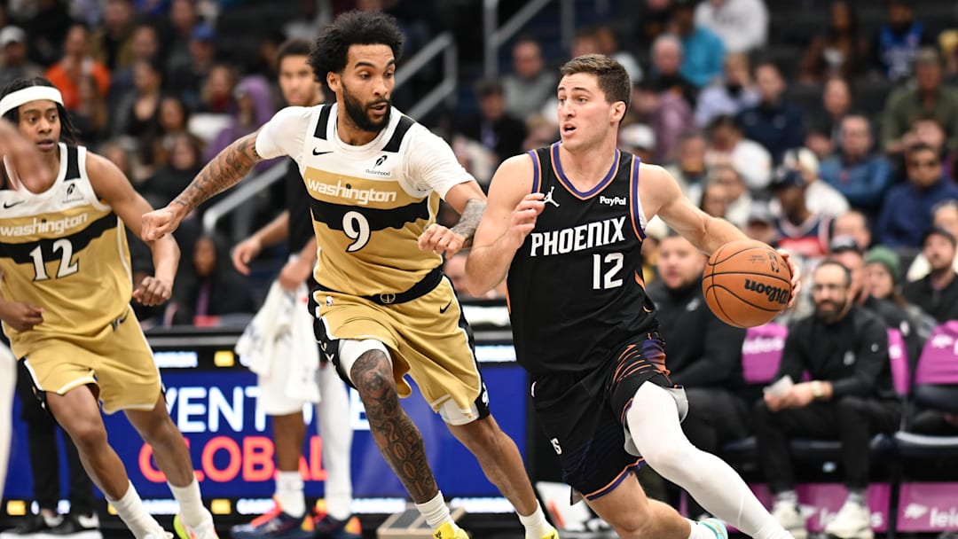 Dec 29, 2025; Washington, District of Columbia, USA;  Phoenix Suns guard Collin Gillespie (12) dribbles the ball in front of Washington Wizards forward Justin Champagnie (9) during the second quarter at Capital One Arena. Mandatory Credit: Rafael Suanes-Imagn Images