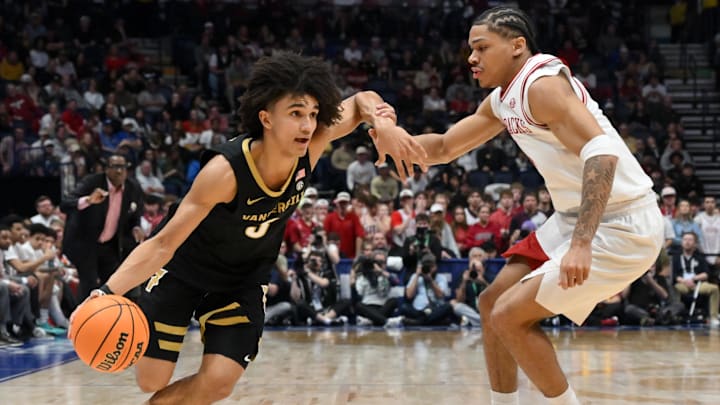 Mar 15, 2026; Nashville, TN, USA; Vanderbilt Commodores guard Tyler Tanner (3) drives to the basket defended by Arkansas Razorbacks guard Darius Acuff Jr. (5) in the second half during the men's SEC Conference Tournament Championship at Bridgestone Arena. Mandatory Credit: Steve Roberts-Imagn Images
