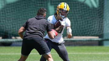 Green Bay Packers receiver Christian Watson goes through a ball-security drill during an offseason practice.