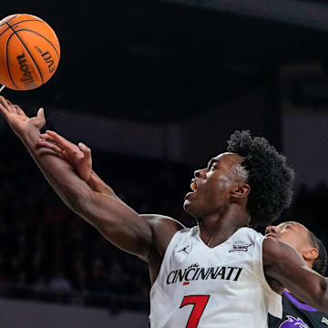 Cincinnati Bearcats guard Keyshuan Tillery (7) is fouled by Western Carolina Catamounts forward Chase McKey (1) on his way to the basket in the first half of the NCAA men’s basketball game between the Cincinnati Bearcats and the Western Carolina Catamounts at Fifth Third Arena in Cincinnati on Monday, Nov. 3, 2025.
