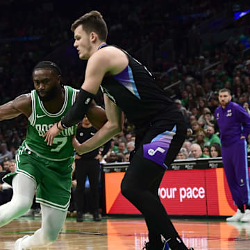 Mar 10, 2025; Boston, Massachusetts, USA;  Boston Celtics guard Jaylen Brown (7) controls the ball while Utah Jazz center Walker Kessler (24) defends during the first half at TD Garden. Mandatory Credit: Bob DeChiara-Imagn Images