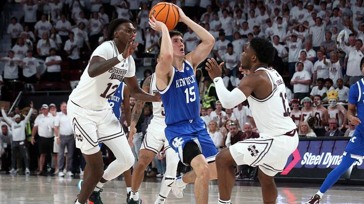 Feb 27, 2024; Starkville, Mississippi, USA; Kentucky Wildcats guard Reed Sheppard (15) scores on the final shot of the game as Mississippi State Bulldogs forward KeShawn Murphy (12) and guard Josh Hubbard (13) defend during the second half at Humphrey Coliseum. Mandatory Credit: Petre Thomas-Imagn Images