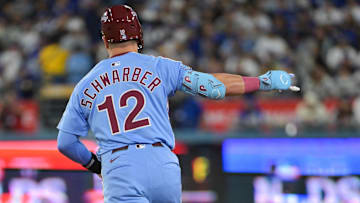 Oct 8, 2025; Los Angeles, California, USA; Philadelphia Phillies designated hitter Kyle Schwarber (12) celebrates after hitting a two run home run during the eighth inning against the Los Angeles Dodgers during game three of the NLDS round for the 2025 MLB playoffs at Dodger Stadium. Mandatory Credit: Jayne Kamin-Oncea-Imagn Images