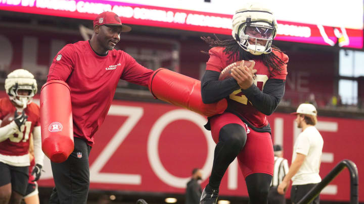 Arizona Cardinals' Deejay Dallas (20) participates in a drill with running back coach Autry Denson during training camp at State Farm Stadium on Aug 6, 2024, in Glendale, Ariz.