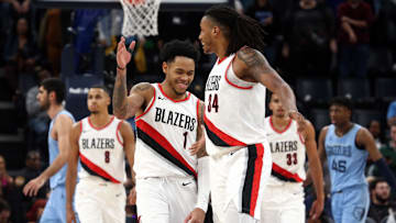 Mar 2, 2024; Memphis, Tennessee, USA; Portland Trail Blazers guard Anfernee Simons (1) reacts with forward Jabari Walker (34) at the end of regulation against the Memphis Grizzlies at FedExForum. Mandatory Credit: Petre Thomas-Imagn Images