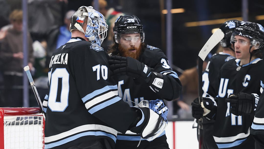Feb 27, 2025; Salt Lake City, Utah, USA;  Utah Hockey Club goaltender Karel Vejmelka (70), center Liam O'Brien (38) and center Nick Schmaltz (8) celebrate a win over the Minnesota Wild at Delta Center. Mandatory Credit: Rob Gray-Imagn Images