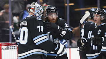 Feb 27, 2025; Salt Lake City, Utah, USA;  Utah Hockey Club goaltender Karel Vejmelka (70), center Liam O'Brien (38) and center Nick Schmaltz (8) celebrate a win over the Minnesota Wild at Delta Center. Mandatory Credit: Rob Gray-Imagn Images