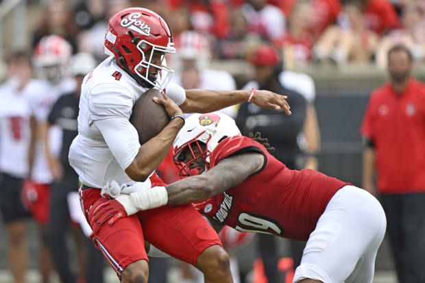 Louisville Cardinals defensive end Tramel Logan (19) sacks Austin Peay Governors quarterback Mason Garcia (12) 