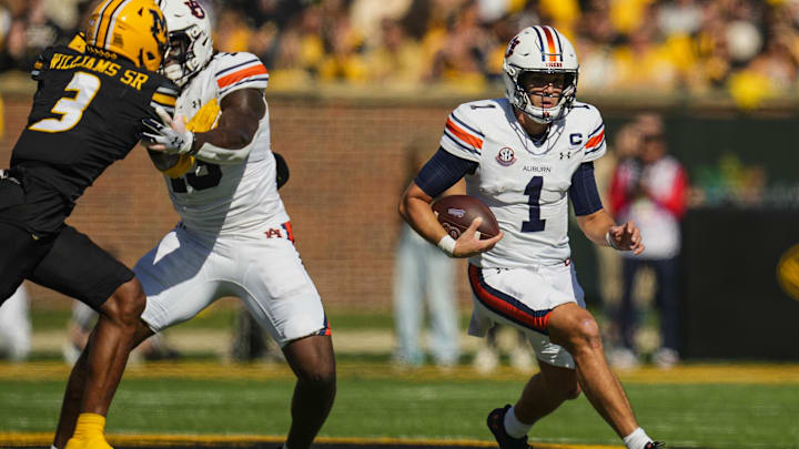 Oct 19, 2024; Columbia, Missouri, USA; Auburn Tigers quarterback Payton Thorne (1) runs the ball against Missouri Tigers safety Sidney Williams (3) during the first half at Faurot Field at Memorial Stadium. Mandatory Credit: Jay Biggerstaff-Imagn Images Oct 19, 2024; Columbia, Missouri, USA; Auburn Tigers quarterback Payton Thorne (1) runs the ball against Missouri Tigers safety Sidney Williams (3) during the first half at Faurot Field at Memorial Stadium. Mandatory Credit: Jay Biggerstaff-Imagn Images