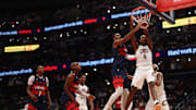 Nov 7, 2025; Washington, District of Columbia, USA; Cleveland Cavaliers center Evan Mobley (4) dunks the ball as Washington Wizards center Alex Sarr (20) defends in the second half in an Emirates NBA Cup game at Capital One Arena. Mandatory Credit: Geoff Burke-Imagn Images