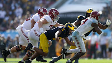 Dec 31, 2024; Tampa, FL, USA;  Alabama Crimson Tide quarterback Jalen Milroe (4) is sacked by Michigan Wolverines defensive back Brandyn Hillman (6) in the third quarter during the ReliaQuest Bowl at Raymond James Stadium. Mandatory Credit: Nathan Ray Seebeck-Imagn Images