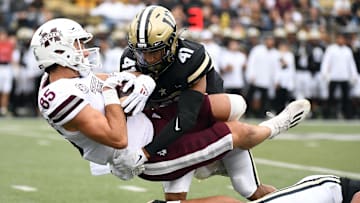 Oct 23, 2021; Nashville, Tennessee, USA; Mississippi State Bulldogs wide receiver Austin Williams (85) is tackled by Vanderbilt Commodores cornerback Tyson Russell (41) after a reception during the first half at Vanderbilt Stadium. Mandatory Credit: Christopher Hanewinckel-Imagn Images