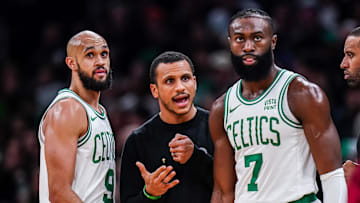 Dec 14, 2023; Boston, Massachusetts, USA; Boston Celtics head coach Joe Mazzulla talks with guard Jaylen Brown (7) and guard Derrick White (9) from the sideline as they take on the Cleveland Cavaliers at TD Garden. Mandatory Credit: David Butler II-Imagn Images