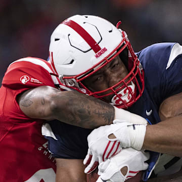 West running back Devine Ozigbo of Nebraska runs the ball as East cornerback Derrick Baity Jr of Kentucky and linebacker Ulysees Gilbert III of Akron defend.