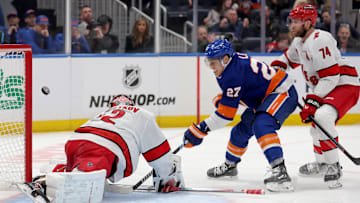 Jan 25, 2025; Elmont, New York, USA; New York Islanders left wing Anders Lee (27) scores the game tying goal against Carolina Hurricanes goaltender Pyotr Kochetkov (52) and defenseman Jaccob Slavin (74) during the third period at UBS Arena. Mandatory Credit: Brad Penner-Imagn Images