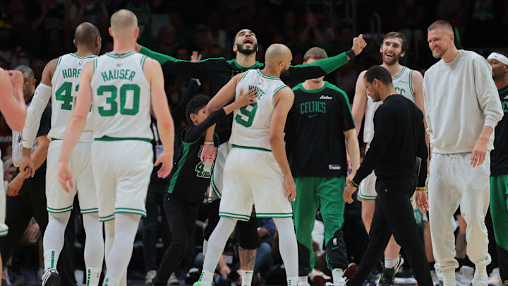 Mar 14, 2025; Miami, Florida, USA; Boston Celtics forward Jayson Tatum (0) celebrates with guard Derrick White (9) against the Miami Heat during the fourth quarter at Kaseya Center. Mandatory Credit: Sam Navarro-Imagn Images