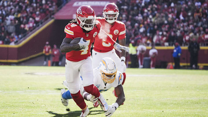 Dec 14, 2025; Kansas City, Missouri, USA; Kansas City Chiefs wide receiver Rashee Rice (4) rushes against Los Angeles Chargers linebacker Daiyan Henley (0) during the first quarter  at GEHA Field at Arrowhead Stadium. Mandatory Credit: Denny Medley-Imagn Images